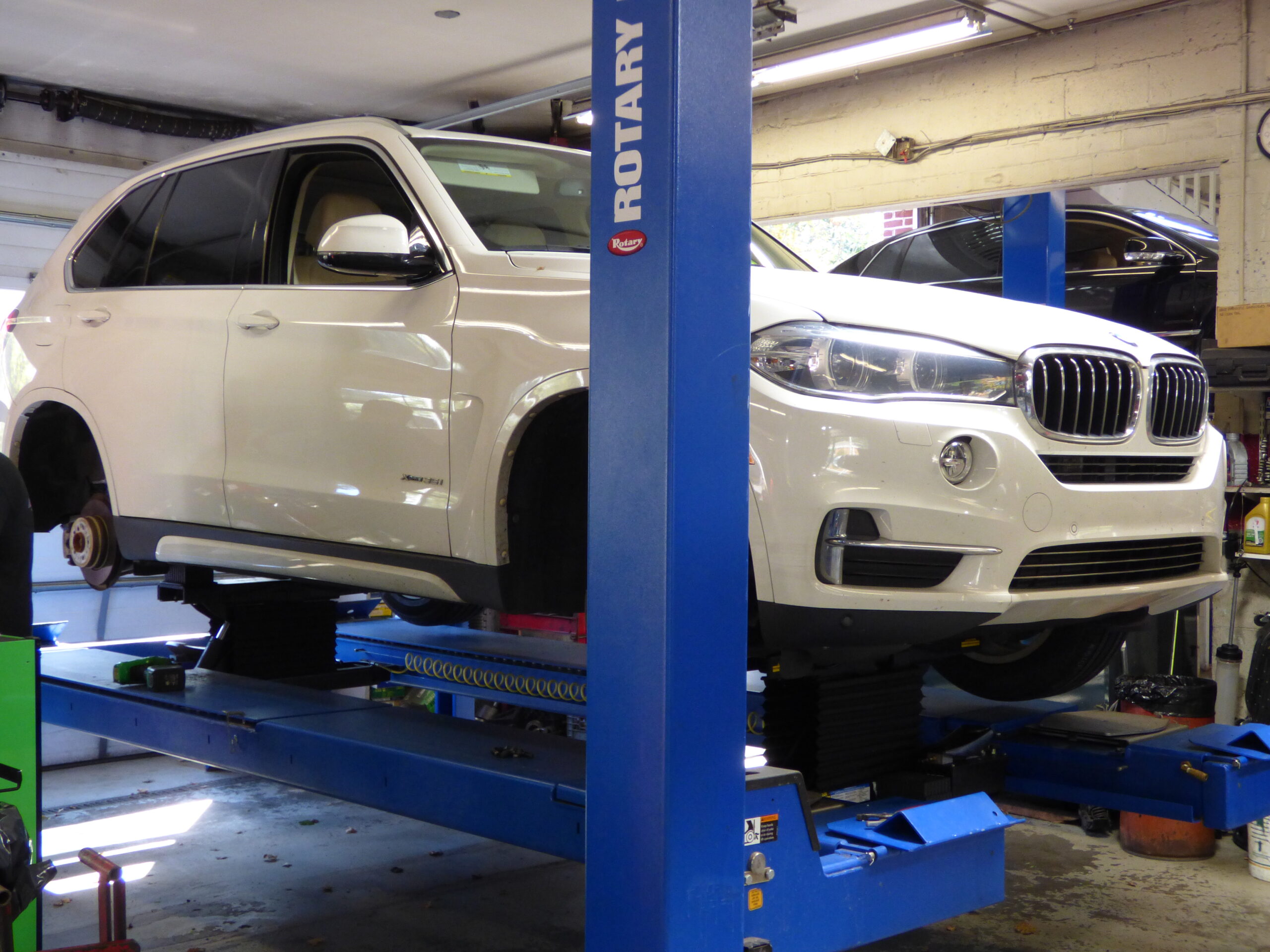 White BMW on lift at Imported Auto Center